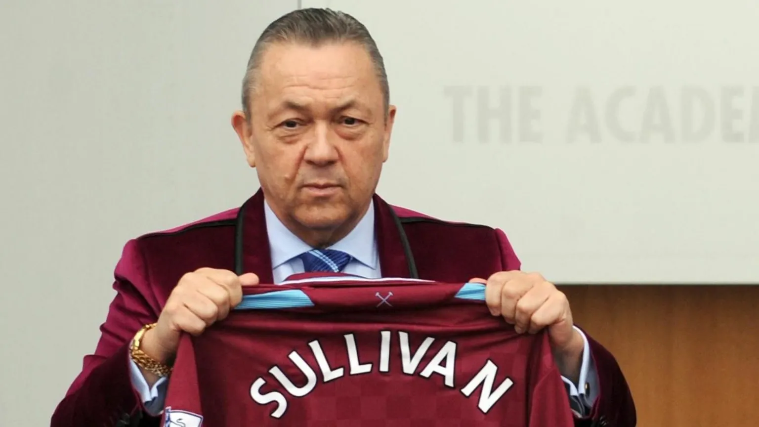  West Ham co-owner David Sullivan is holding a maroon shirt featuring his name, in a photograph dated 19 January 2010.