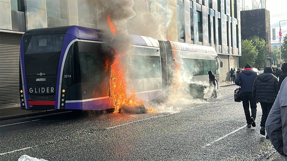A Glider bus, set fire by protesters, on the Newtownards Road in east Belfast, as disorder flared during an anti-immigration demonstration organised in response to Monday night's stabbing attack in the city.