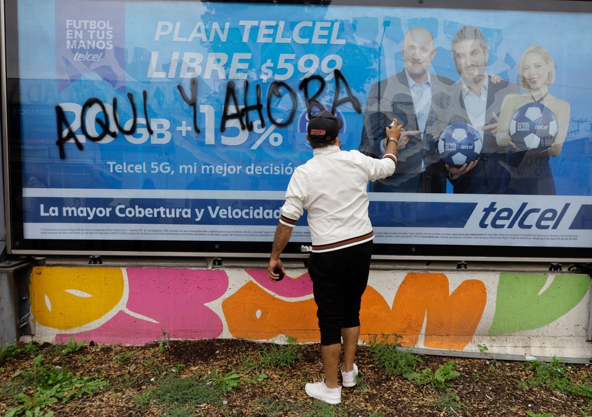 A protester defaces a billboard