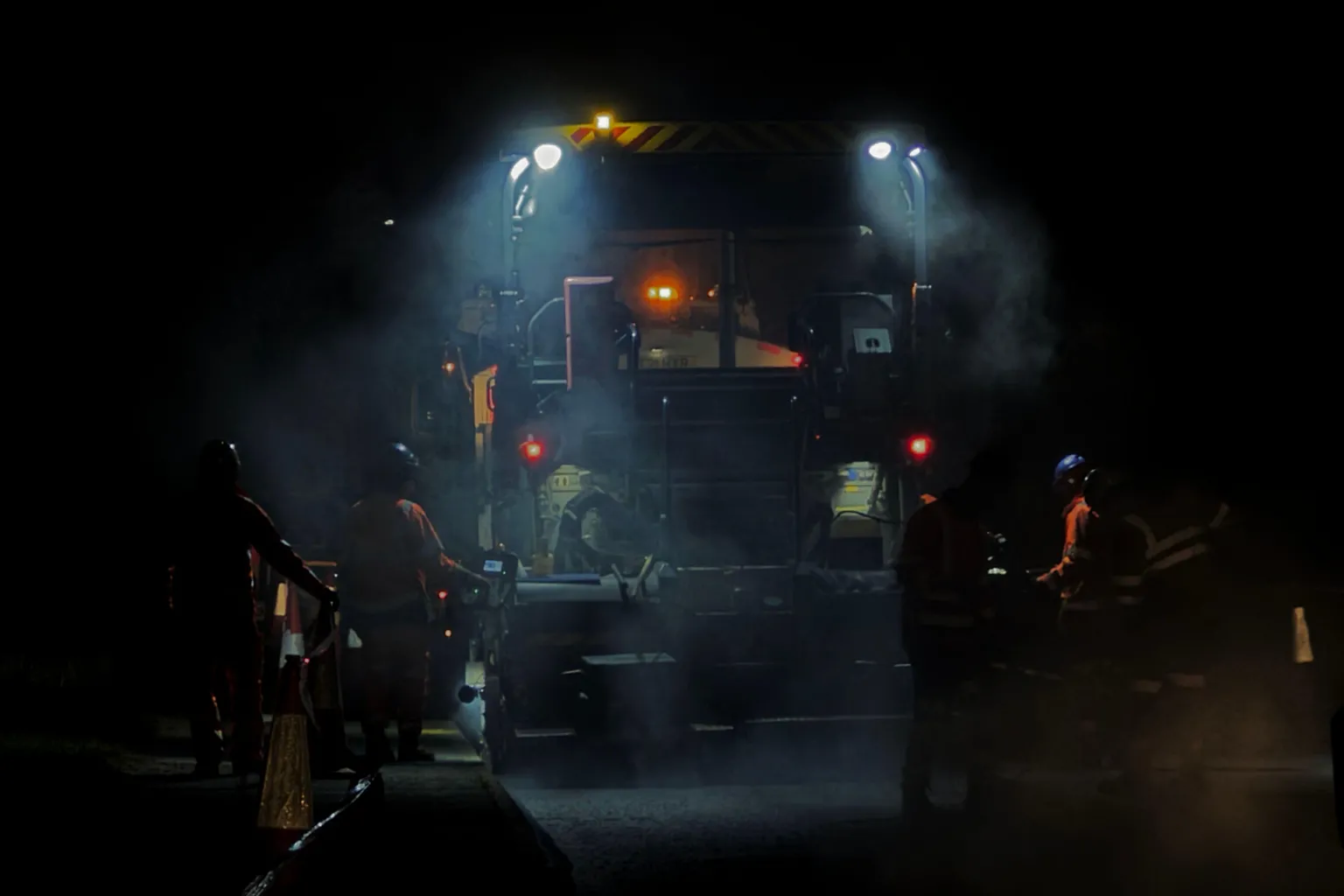 A team from Essex Highways works to repair Turner Road using heavy machines at night.