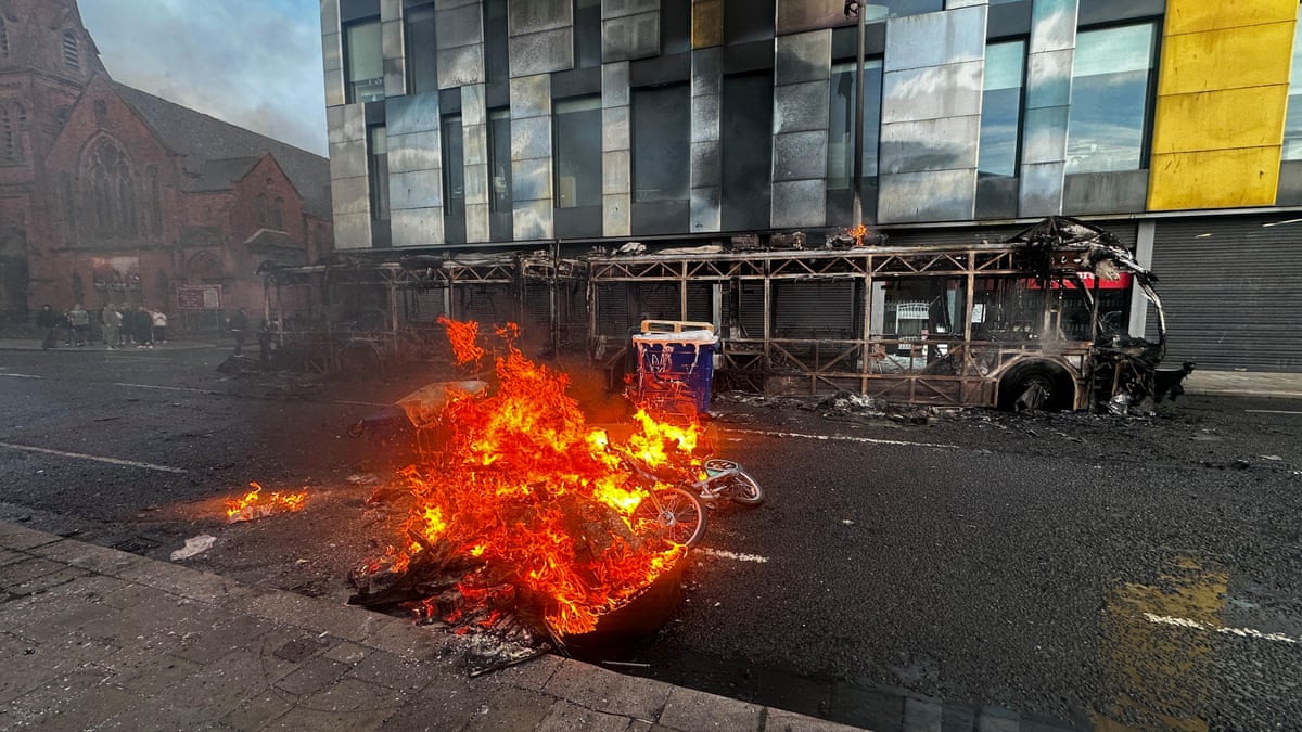 Bus and cars burned in anti-immigration protests in Belfast after stabbing – video
