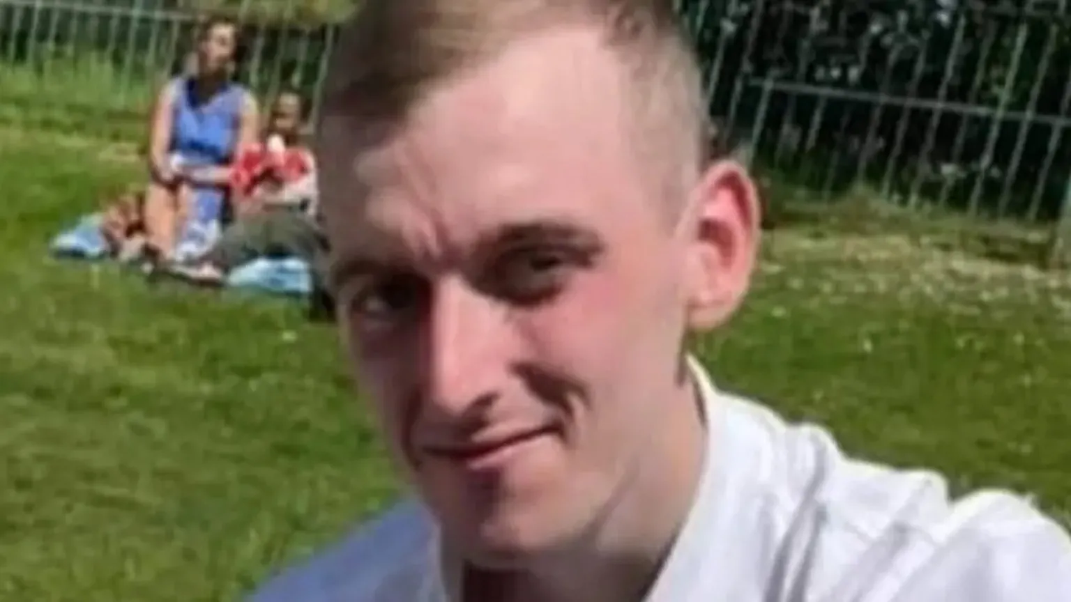 Police Scotland Robert Fisher, with short, fair hair and a white shirt, is pictured in a park.