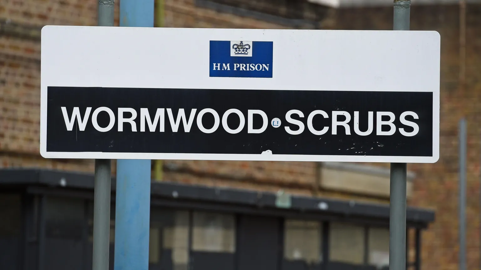 Wormwood Scrubs sign with white writing on black background