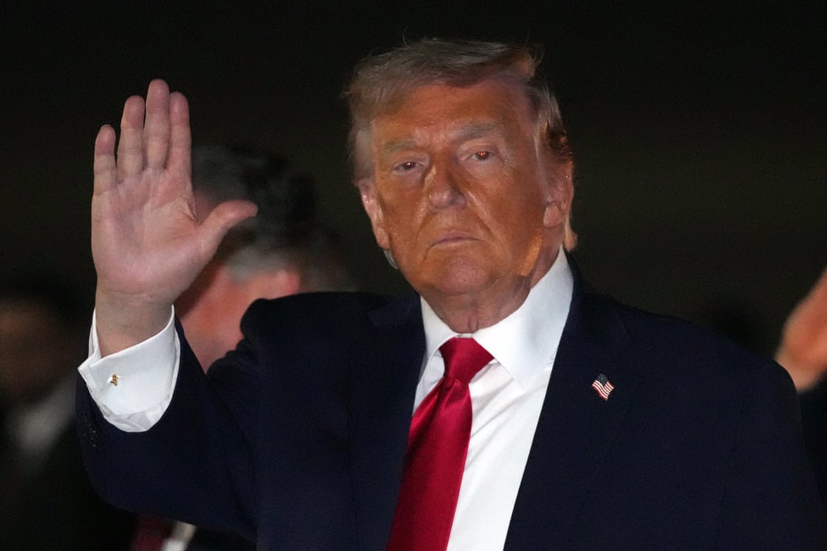 Donald Trump waves at night