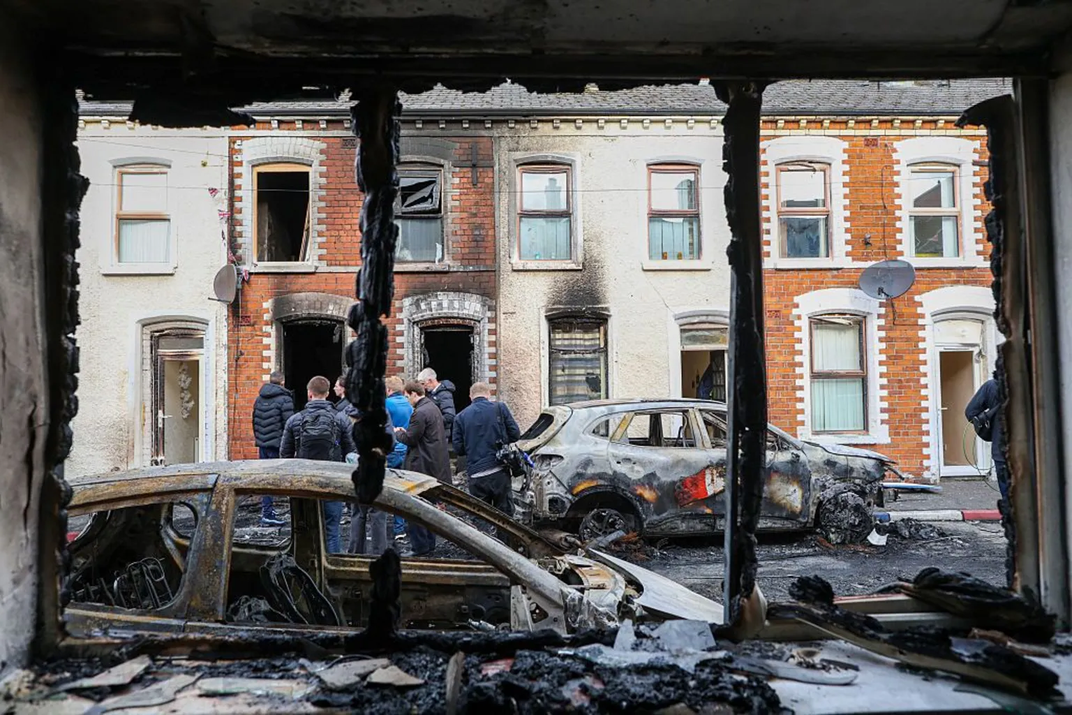 Paul Faith via A burnt out house looking onto burnt cars and a burnt house