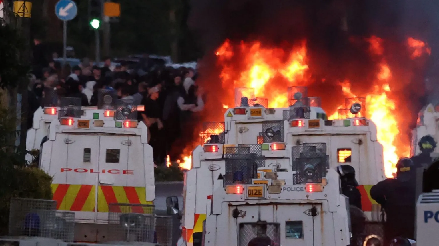  Rioters have set fire to wheelie bins and removed a garden fence to use as a shield against a police water cannon on Antrim Road, at the Sandyknowes roundabout in Newtownabbey.