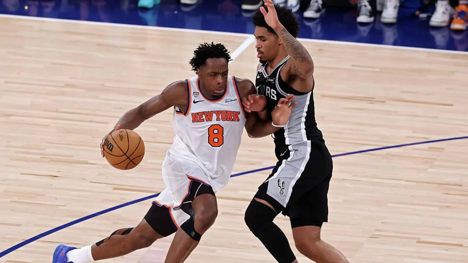 OG Anunoby #8 of the New York Knicks drives to the basket against Dylan Harper #2 of the San Antonio Spurs during the second quarter in Game Four of the 2026 NBA Finals at Madison Square Garden on June 10, 2026 in New York City.
