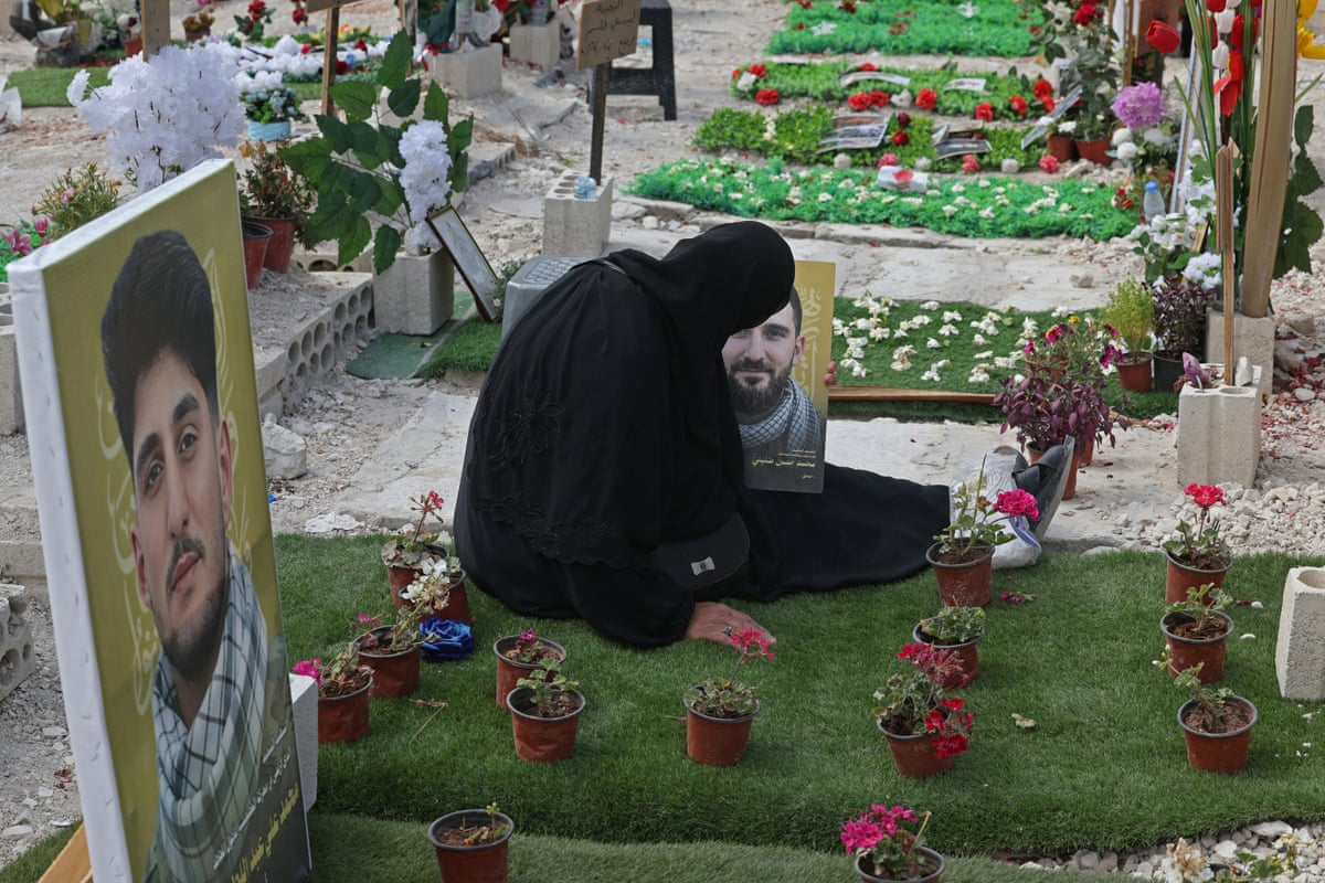 Ghada Hussein mourns at the grave of her son Mohammed Tufayli at a makeshift cemetery in Sidon, Lebanon