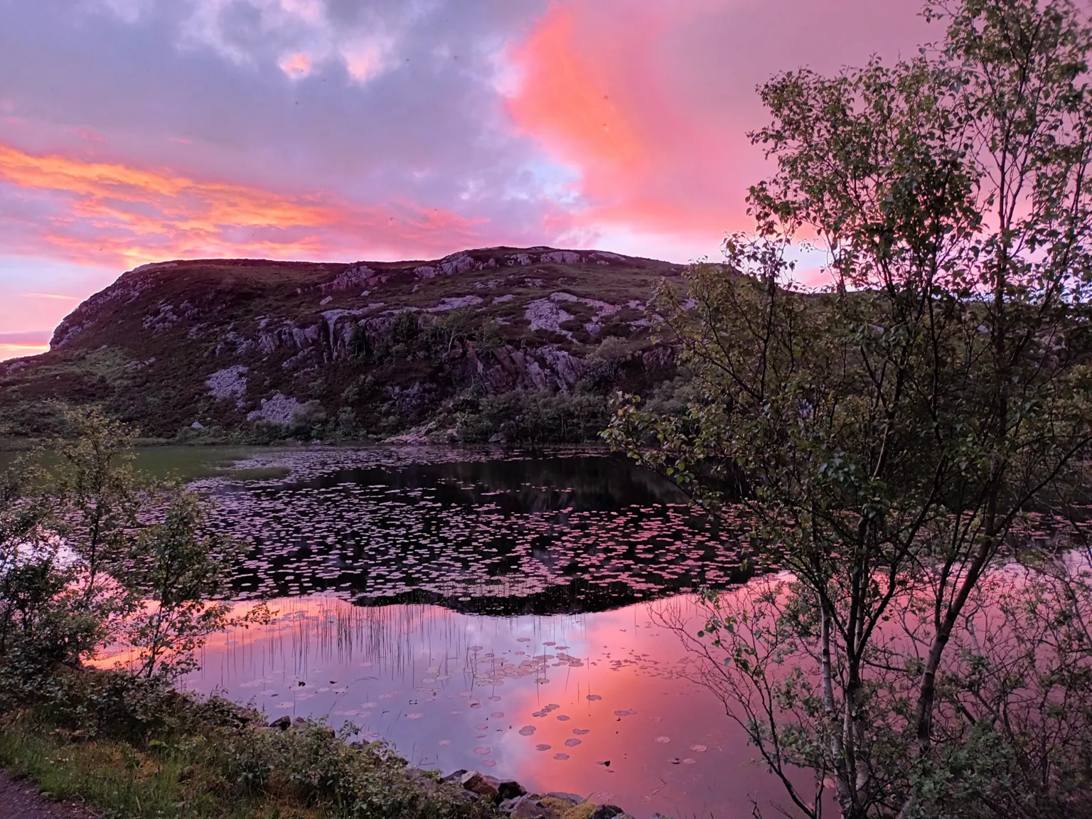 Lynn Martin A sunset with a pink sky over the fishing hamlet of Kylesku