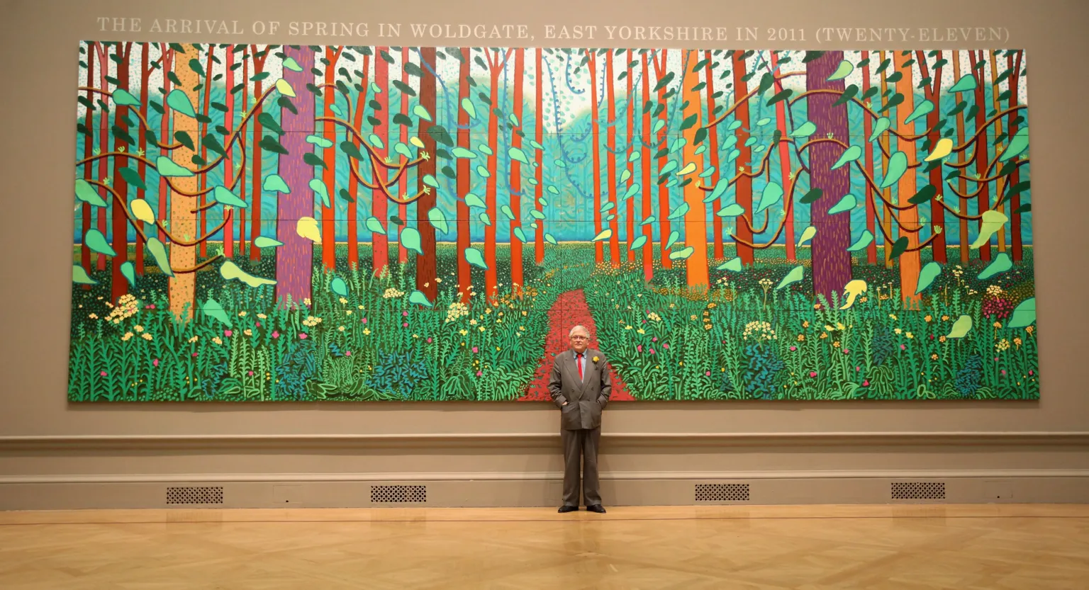 British artist David Hockney poses in front of his painting entitled