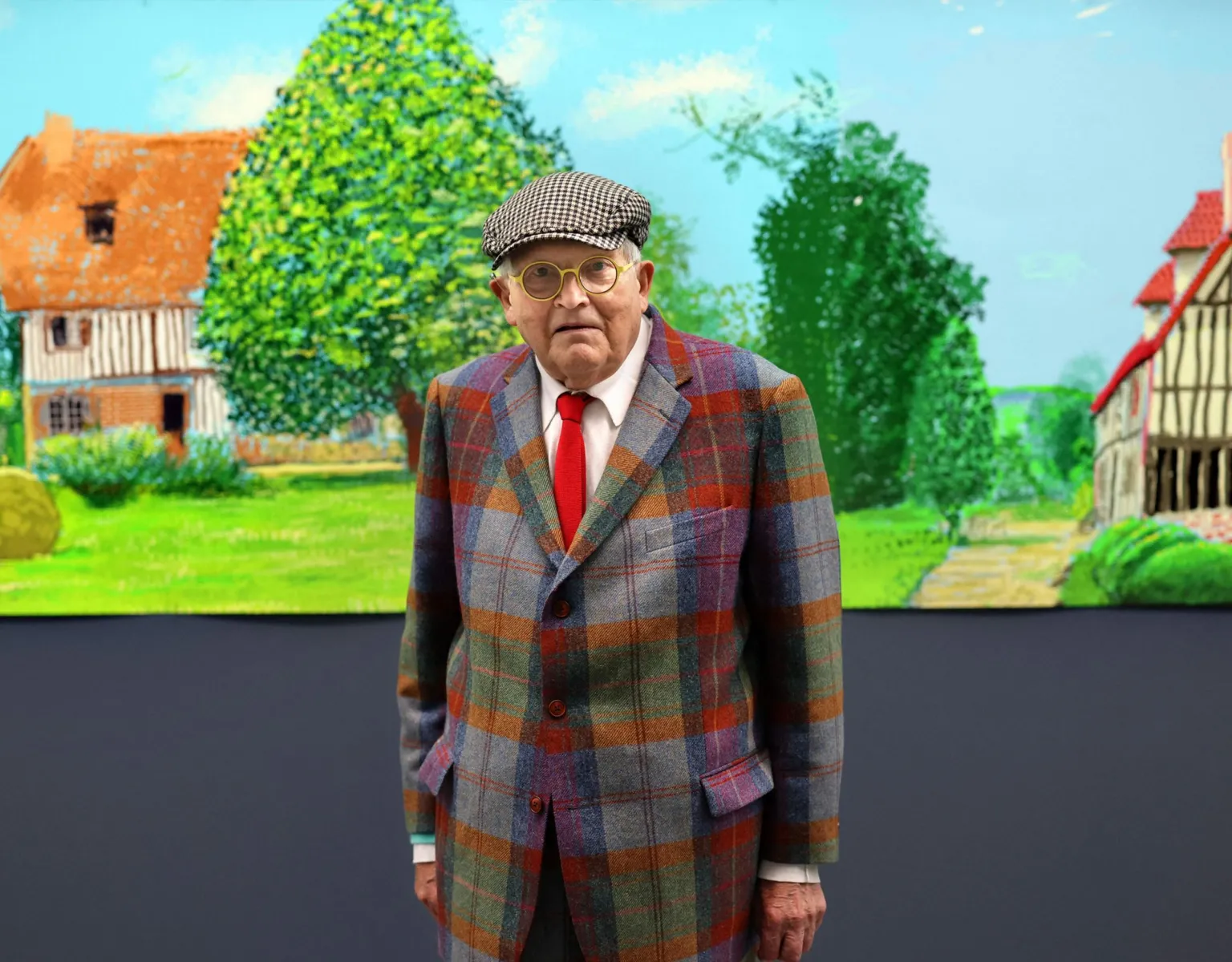 AFP via British painter David Hockney poses at the Orangerie museum in Paris, on October 7, 2021, in front of his painting