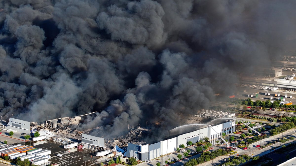 Thick black smoke rises from fire at California medical equipment warehouse – video