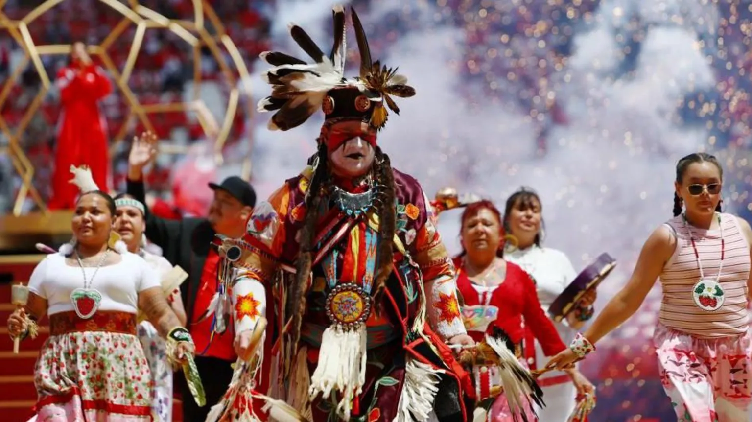 A native person in full regalia performs