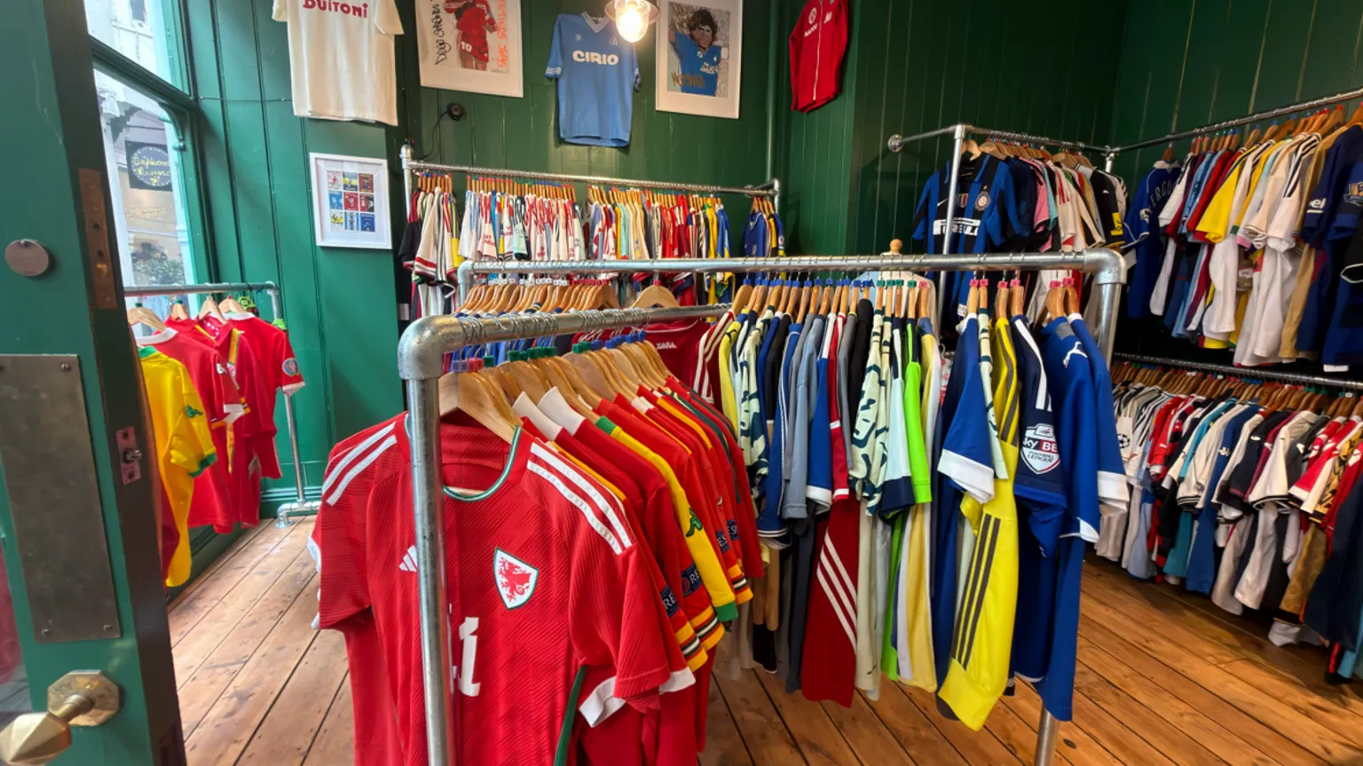 Cowshed Inside a shop with hundreds of vintage football shirts on rails.
