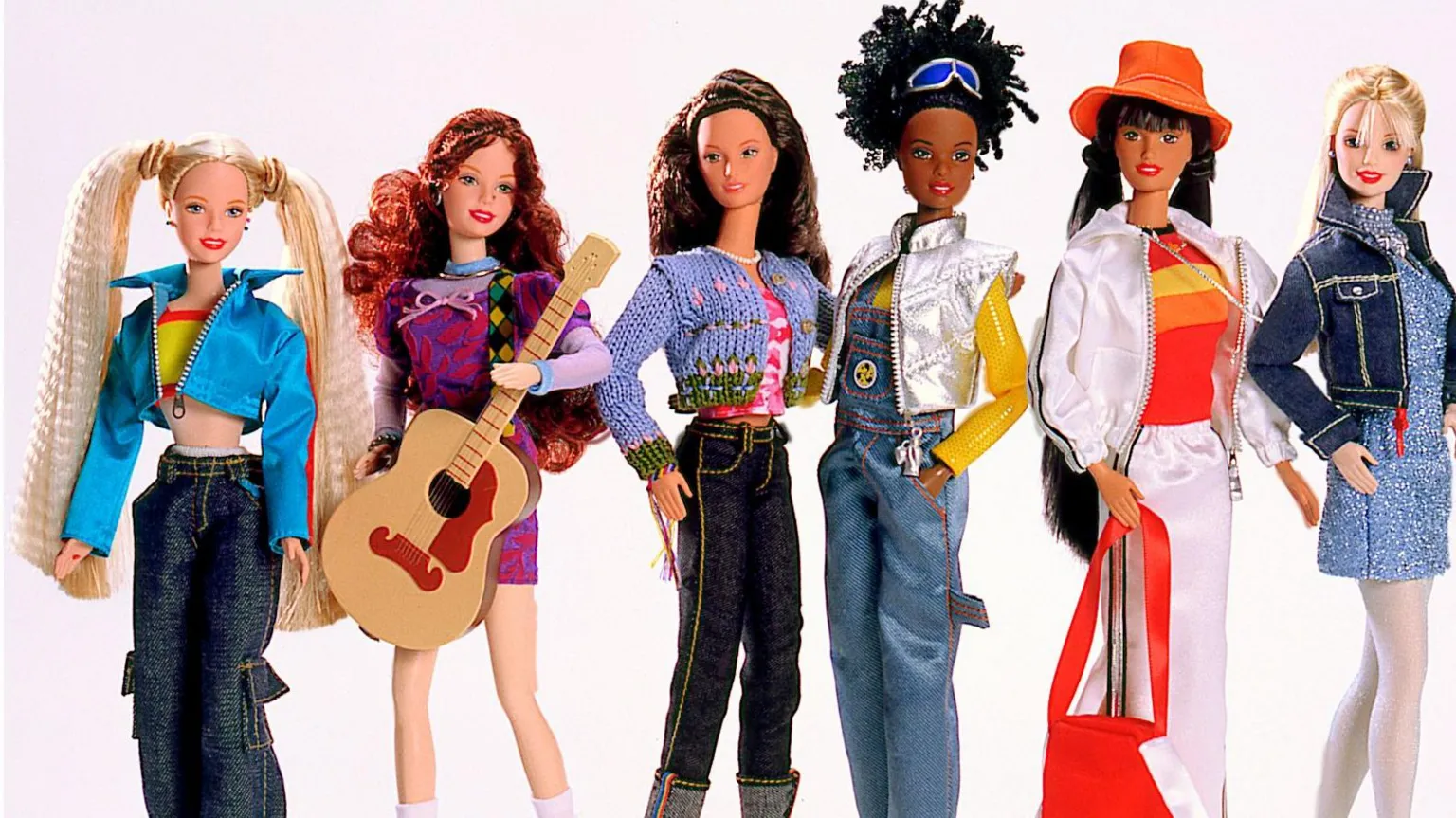 Mattel Inc Six fashion dolls posed side by side against a plain background, each wearing colorful outfits. One doll has long pigtails and a blue jacket with jeans, another holds a guitar and wears a purple dress, while the others wear casual clothes including denim, knit tops, a silver vest, and a white outfit with an orange hat and red bag.