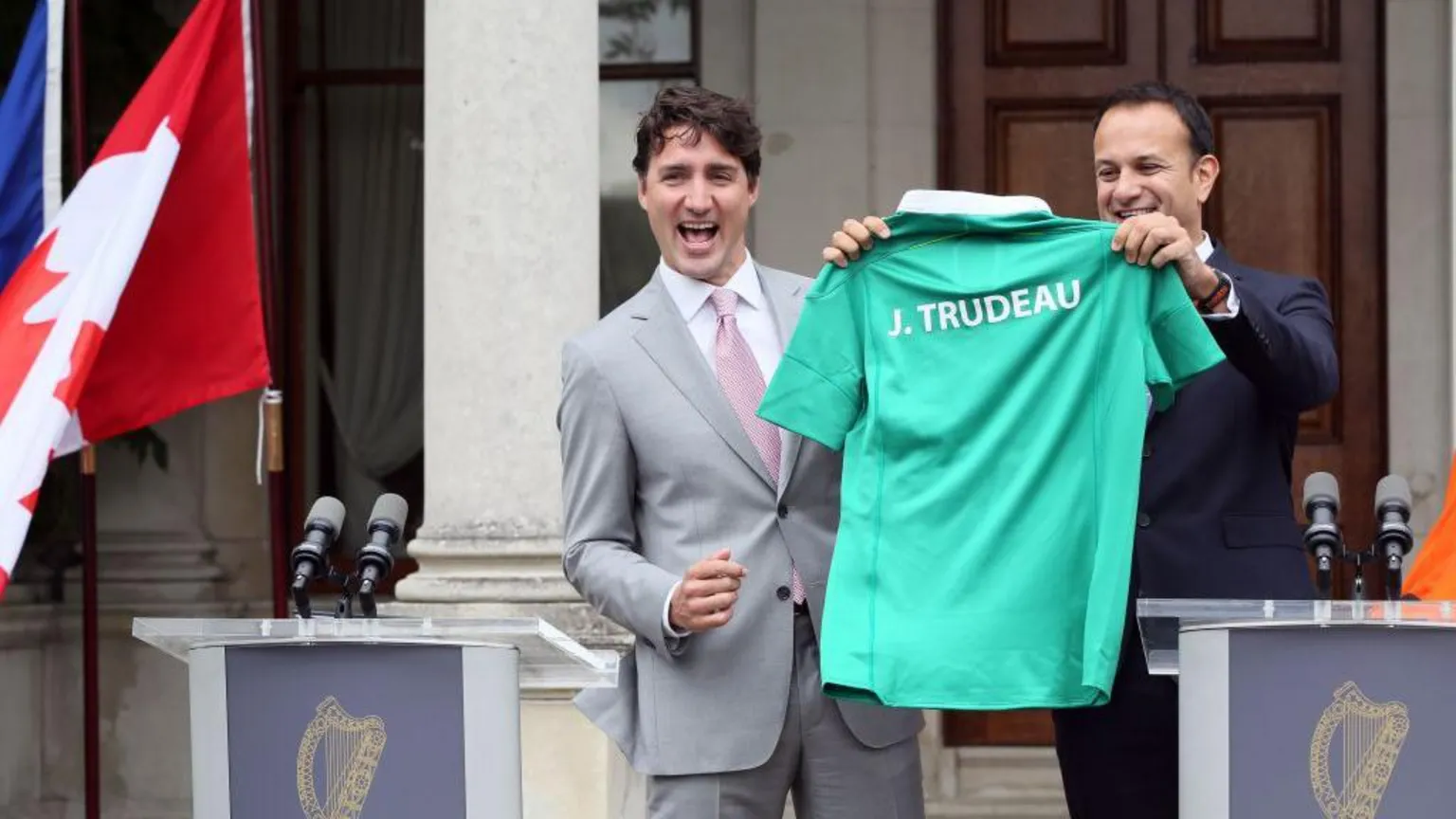 PAUL FAITH/AFP via ) Former Canadian Prime Minister Justin Trudeau (L) is presented with an Ireland rugby union shirt and a pair of socks, by Ireland's Prime Minister Leo Varadkar (R) at Farmleigh House in Dublin on July 4, 2017.