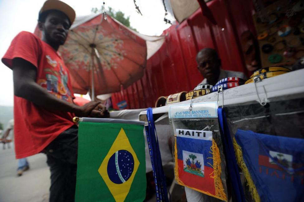 A street vendor selling Brazilian and Haitian flags
