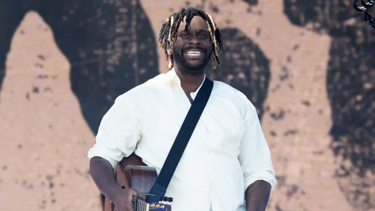  Myles Smith wears a white shirt and smiles whilst performing during Radio 1's Big Weekend at Herrington Country Park on May 23, 2026 in Sunderland.
