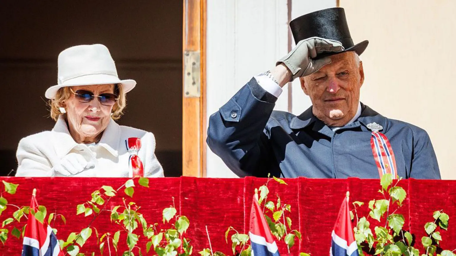 Per Ole Hagen/ A man and woman on a platform in front of Norwegian flags