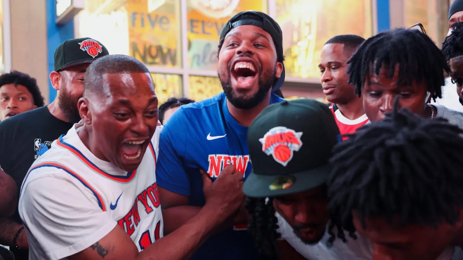 /Shannon Stapleton Fans celebrate as they watch the match on a phone along 42nd Street in Times Square, on the day of Game 5 of the NBA Finals 