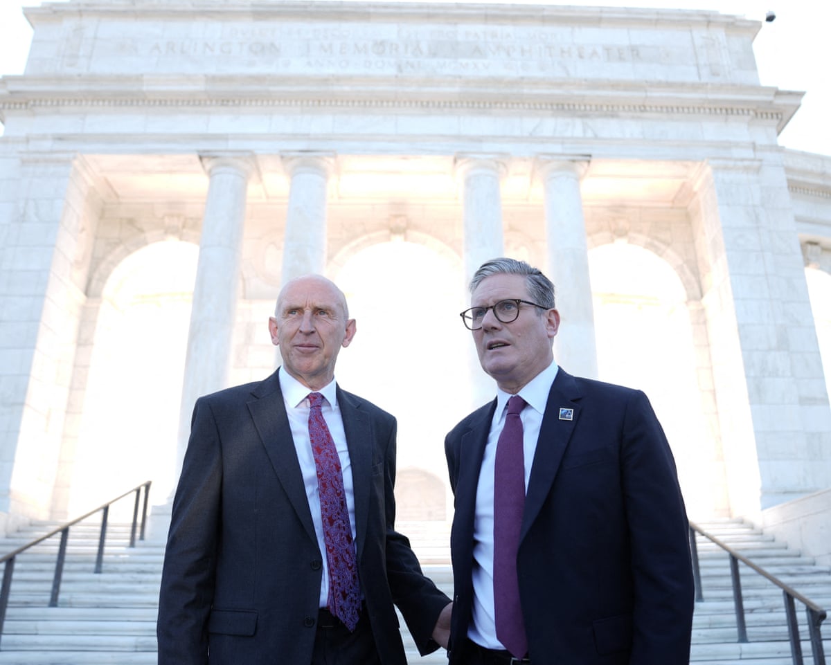 Healey and Starmer stand at the base of the steps of a large white cemetery monument