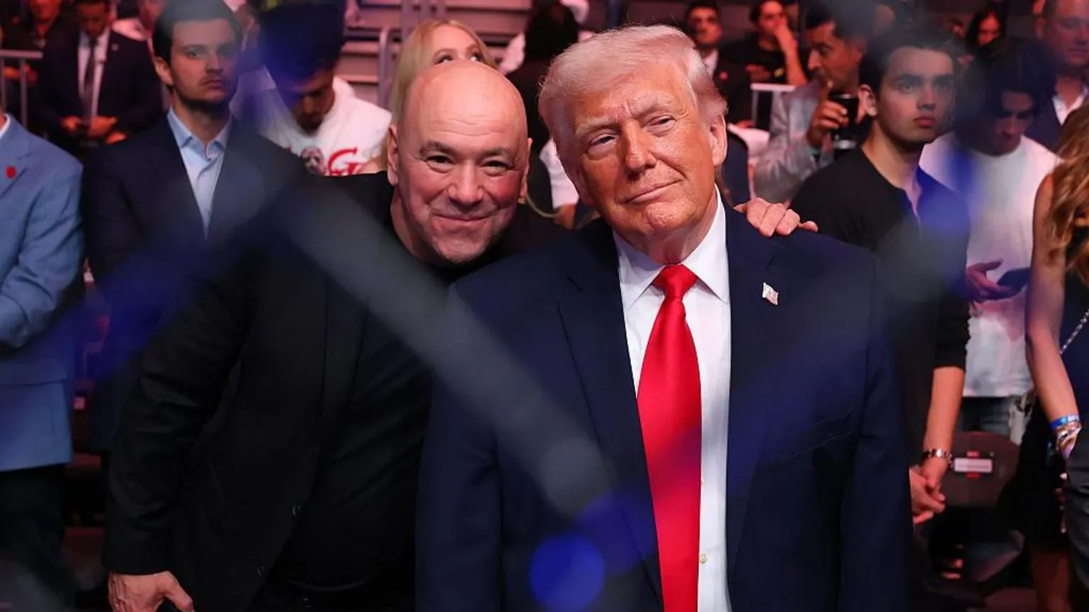 Zuffa LLC via Trump and Dana White standing beside each other and smiling in front of a crowd