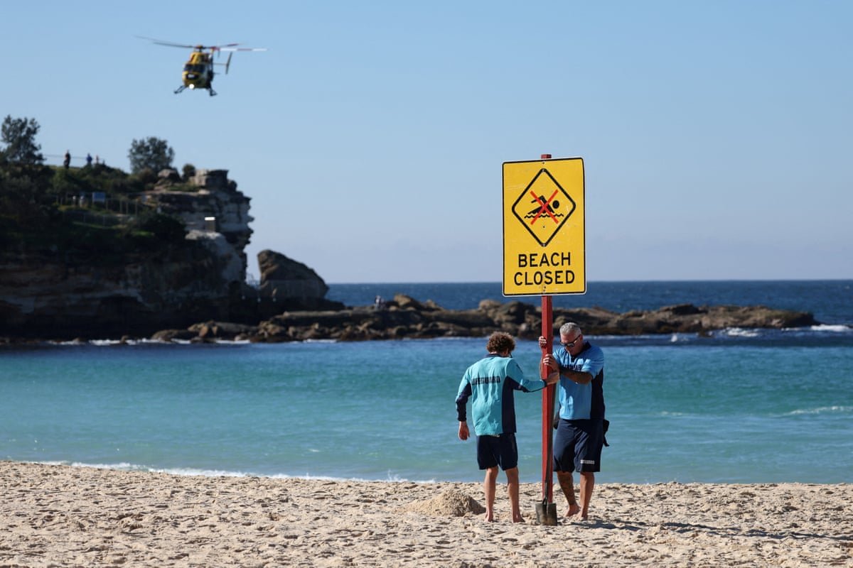 Lifeguards erect a sign that says “Beach Closed” at Coogee beach in Sydney.