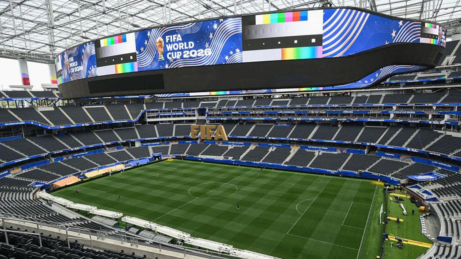 A very large stadium with blue World Cup livery. It is empty.