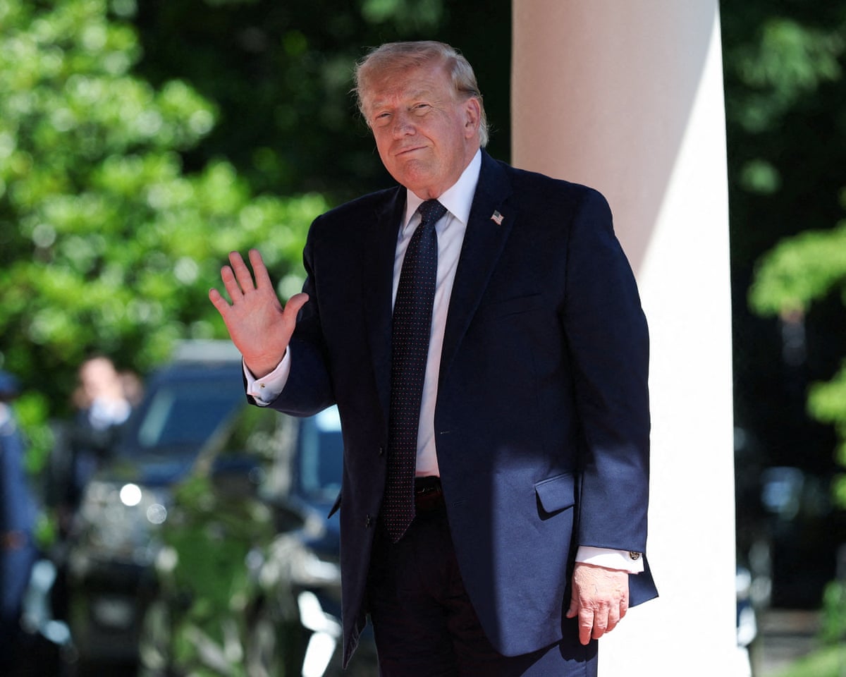 Donald Trump waves as he arrives for the G7 summit, in Evian-les-Bains.