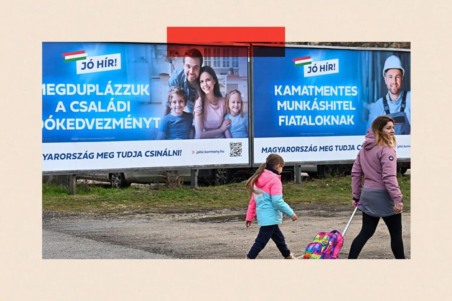 AFP via A woman and a child walk past posters in Hungarian about pronatalist policies 