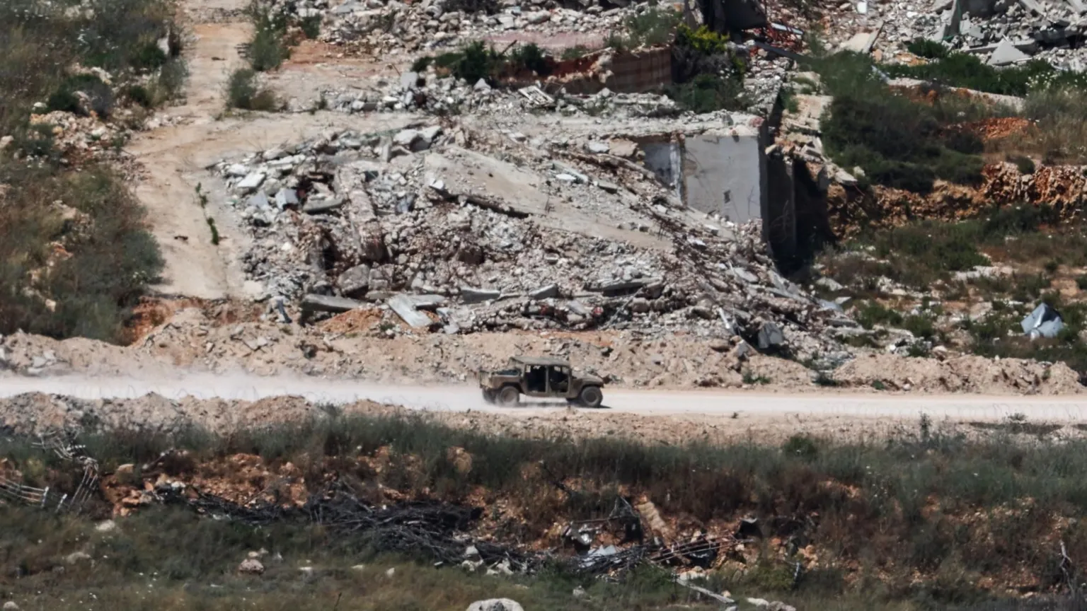 EPA An Israeli military vehicle drives along a road on the Lebanese side of the border with Israel, as seen from northern Israel (15 June 2026)