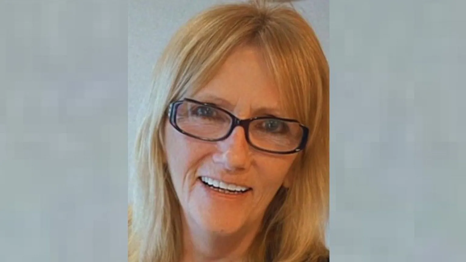 Police Scotland A smiling woman with blonde shoulder-length hair wearing dark-framed glasses