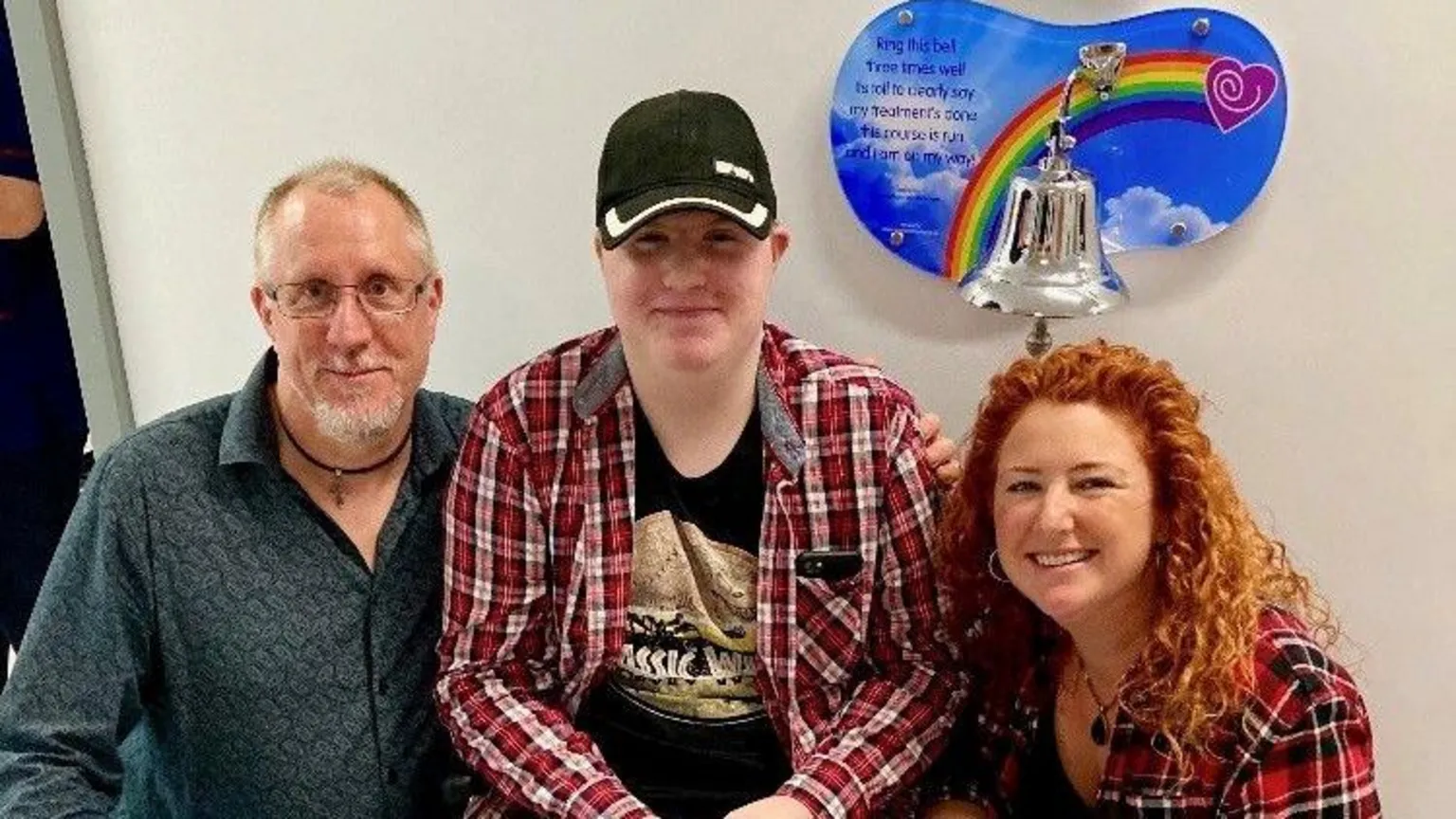 Family photo Jonathan, Daniel and Catherine smiling side by side in hospital