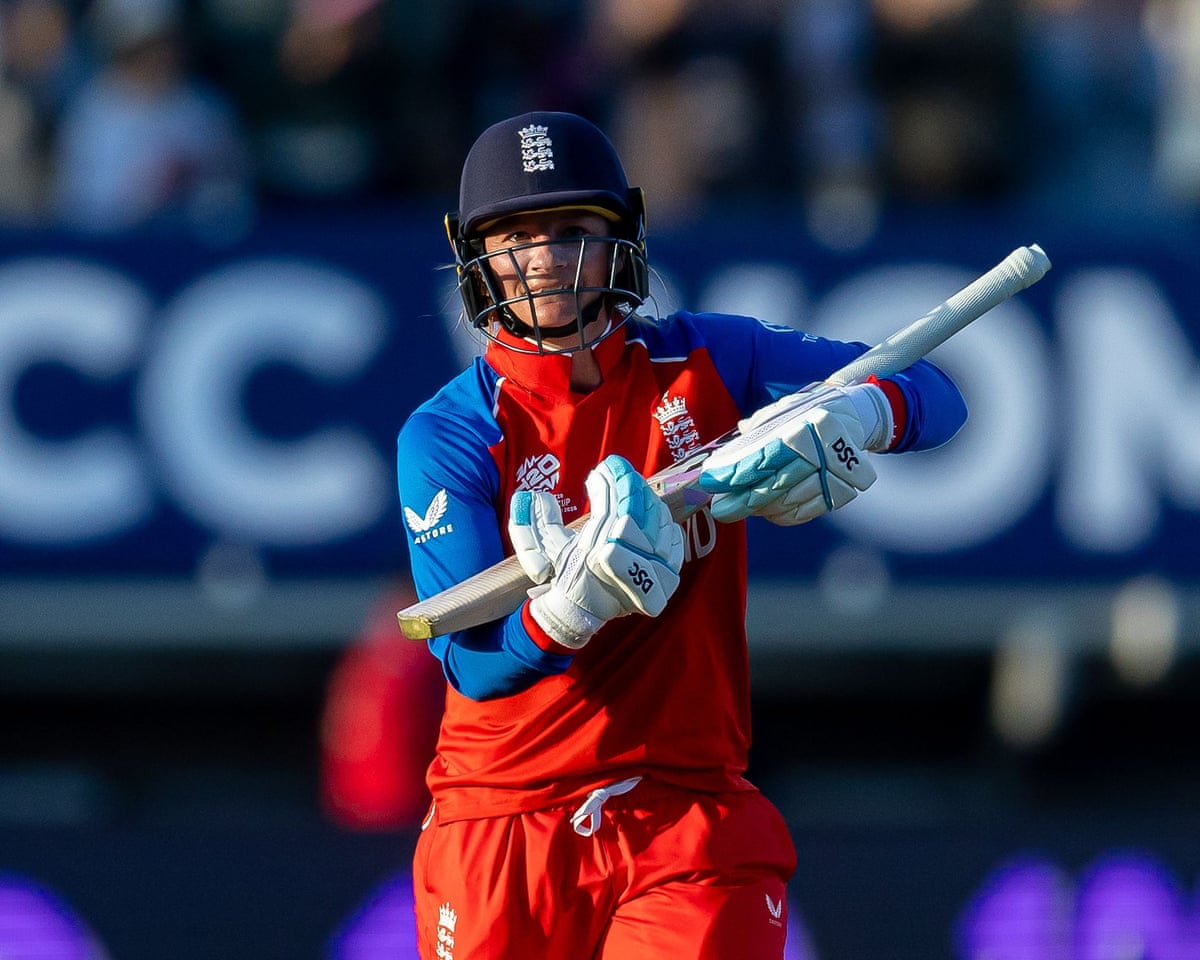 Danni Wyatt-Hodge celebrates reaching a hundred in the T20 World Cup game against Sri Lanka by rocking her bat like a baby