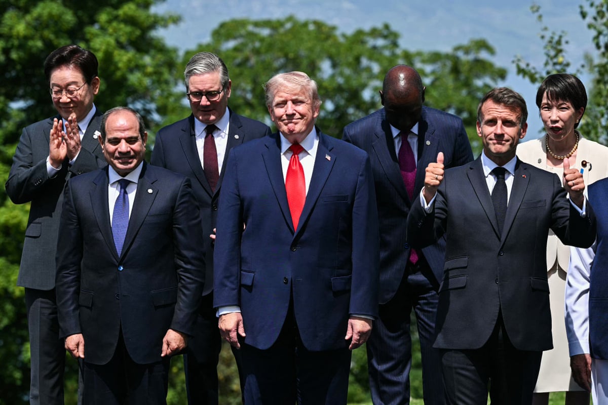 G7 leaders pose for a family photo during the G7 summit, in Evian, eastern France.