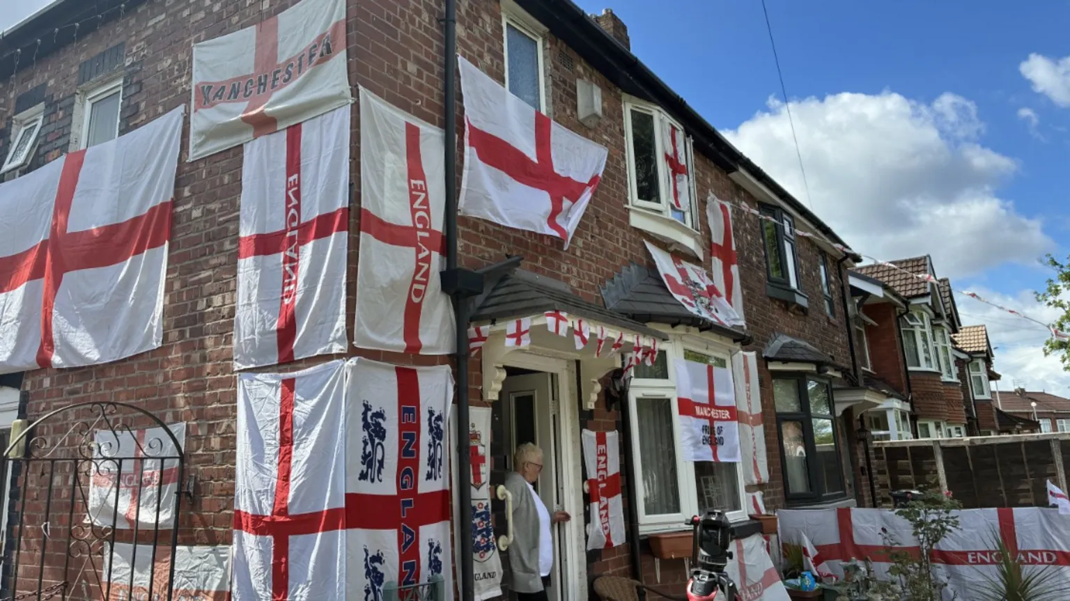 A house covered with various England flags.