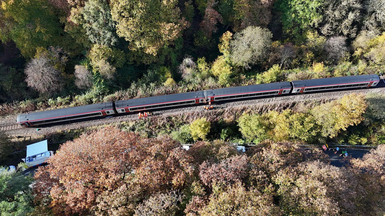 RAIB An aerial picture of a train. Trees surround the track, with people in high-visibility clothes standing by the train.