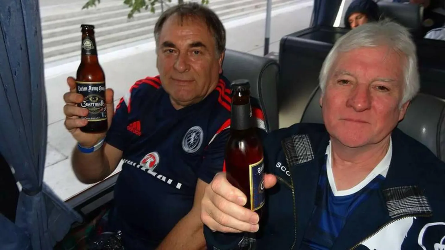Family of Donny Strathie Two members of the tartan army drinkiung beer on a bus
