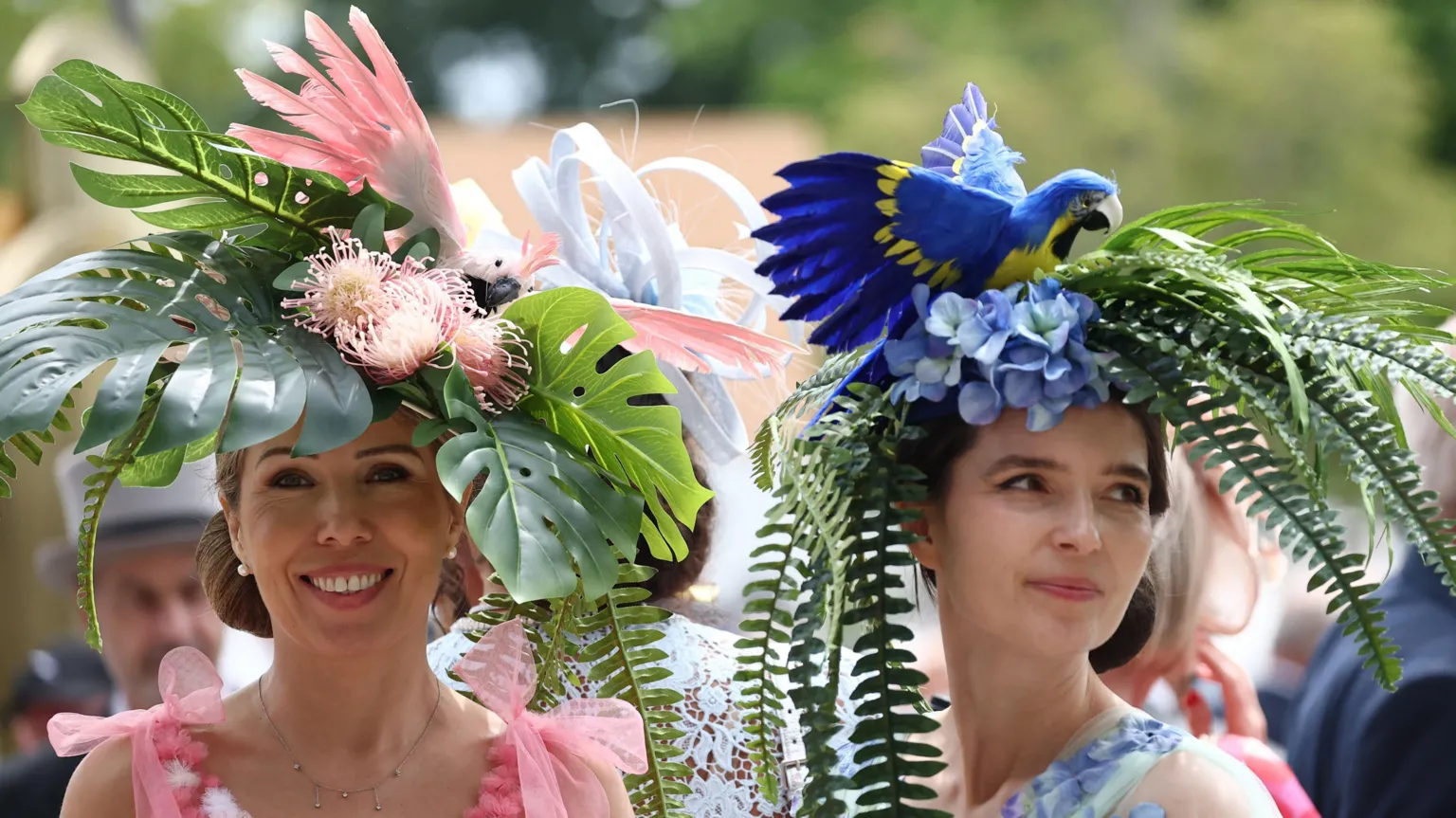 Racegoers wearing bird themed hats arrive ahead of the day's races.