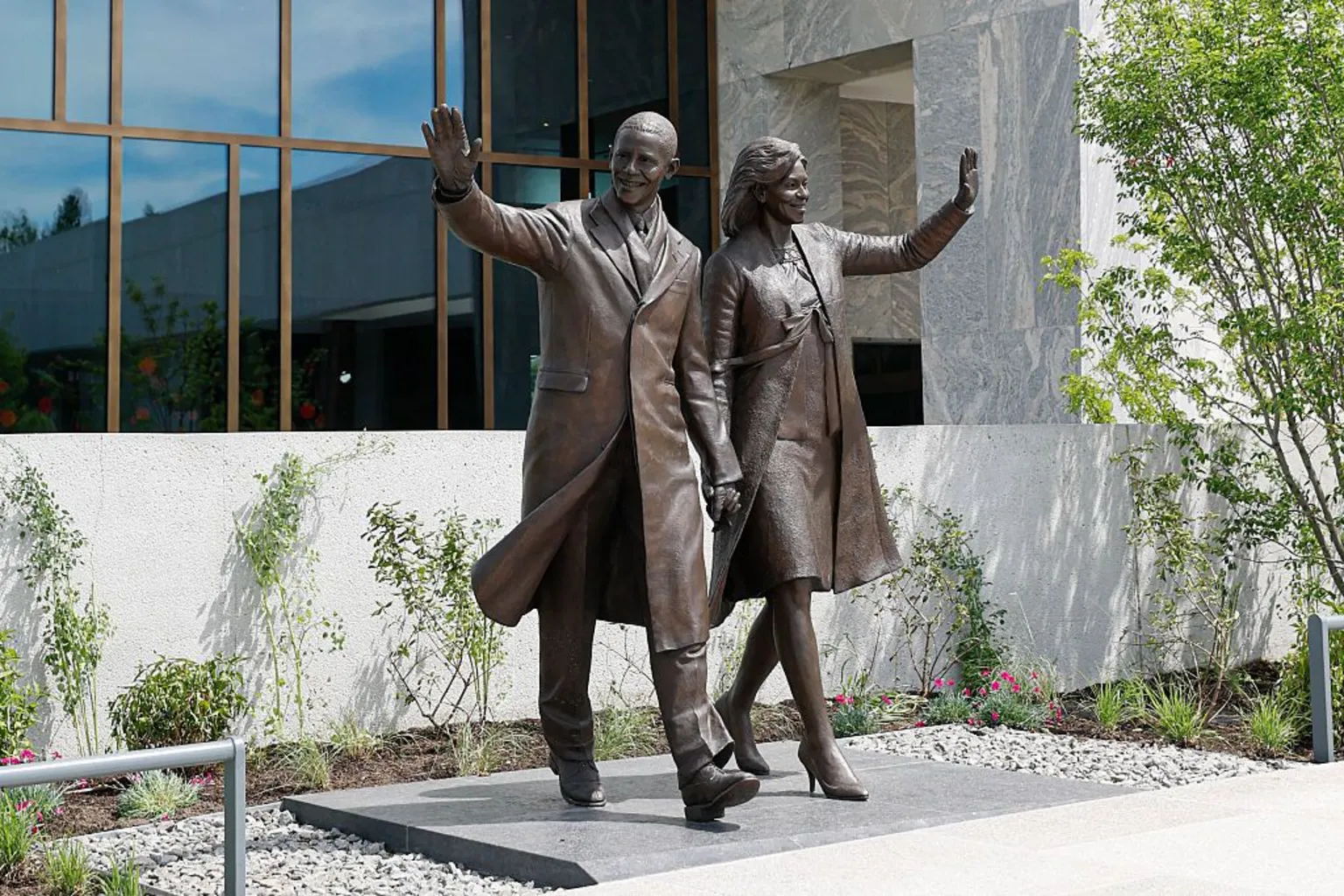 AFP via A bronze statue outside the building depicts Barack and Michelle Obama waving.