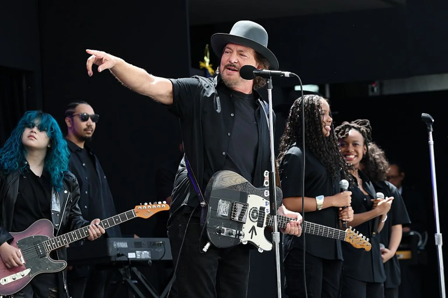 Eddie Vedder points onstage while he performs with Guitars Over Guns during the dedication ceremony.