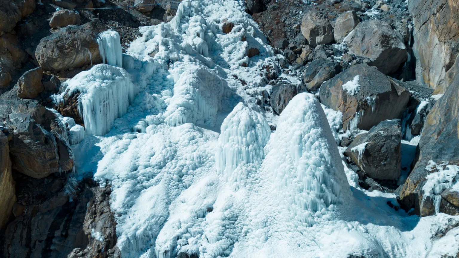 Acres of Ice Towers of ice stand in a rocky gorge.
