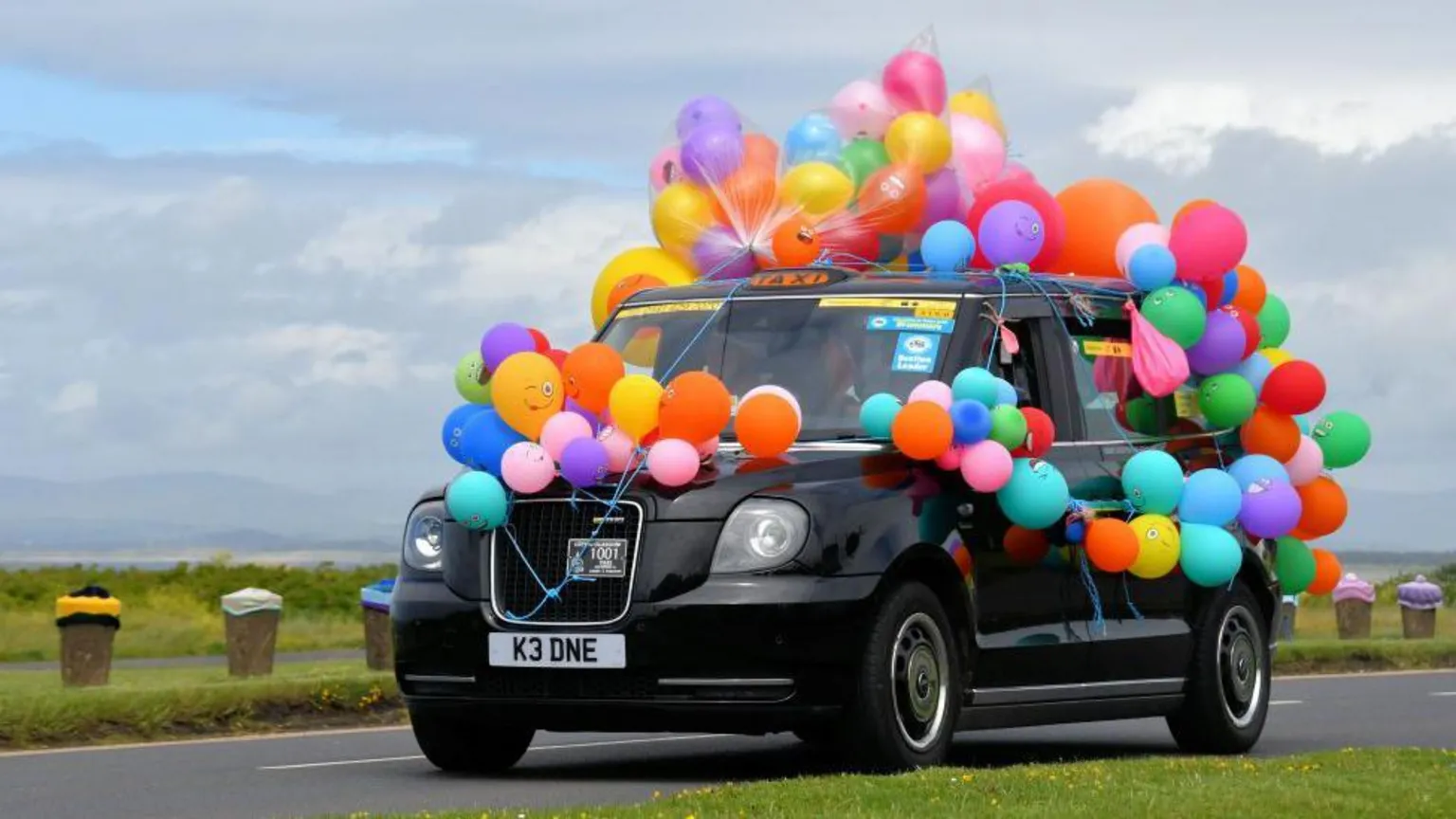 Sylvia Watson A black taxi covered in bright balloons as part of a charity event.