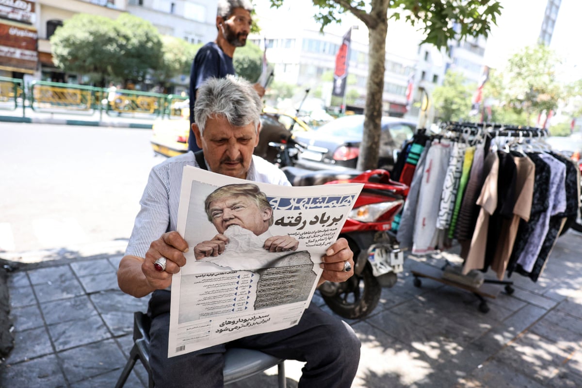 A man in Tehran, Iran, reads a copy of the Iranian daily newspaper Hamshahri bearing an image of Donald Trump and a headline that reads ‘Gone with the wind’.