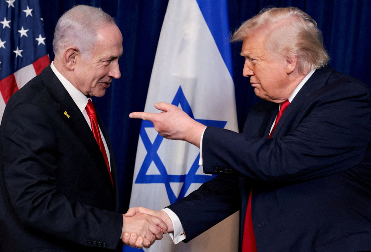 US president Donald Trump points his finger towards Israeli prime minister Benjamin Netanyahu as they shake hands.