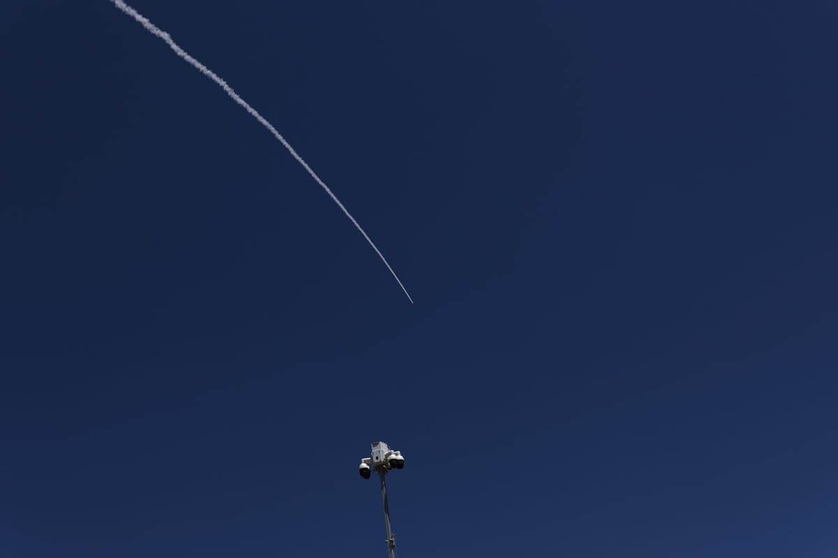 A white line in a clear sky from a projectile being intercepted.