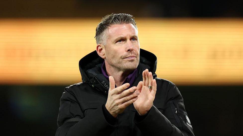 Rob Edwards, Manager of Wolverhampton Wanderers, applauds fan