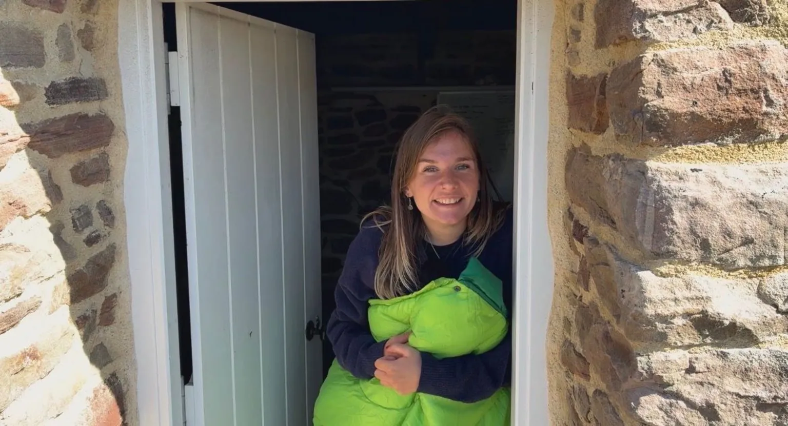 Evie in her sleeping bag at the bothy door