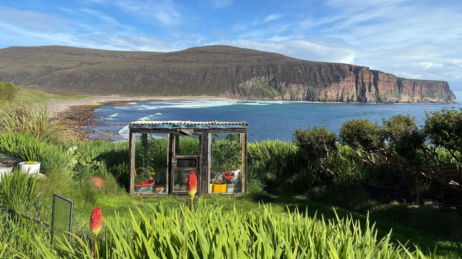 From Davey Hutcheson's garden, you can see a panoramic view of Rackwick bay, and the cliffside towering above it.