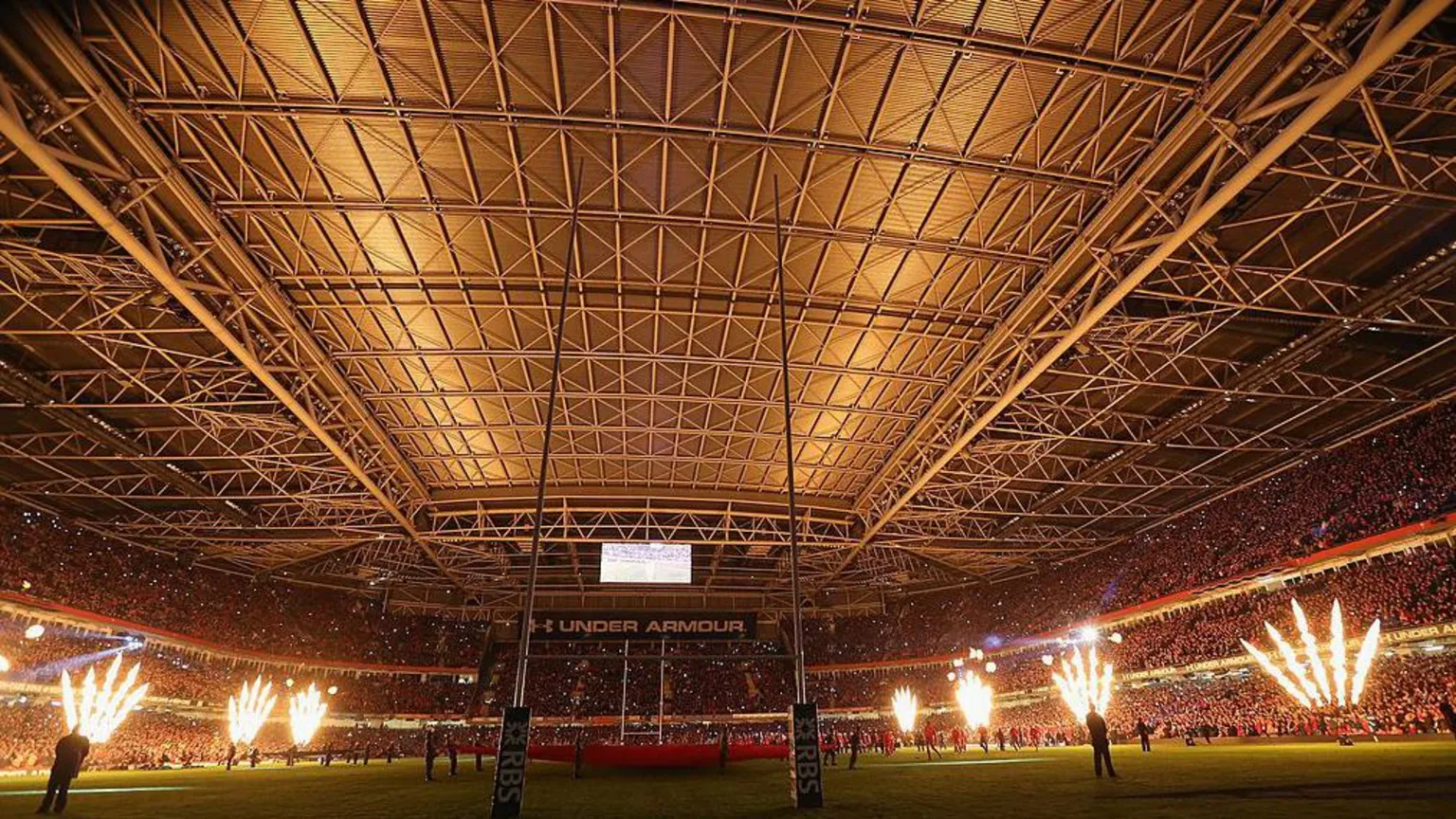 Looking from a south to north pespective, the stadium's closed roof shows its stainless steel panels. Together, they measure 105 meters by 80 meters. Flames greet the teams during the RBS Six Nations match between Wales and France, in 2014